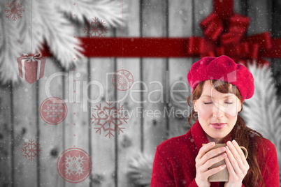 Composite image of woman holding a warm cup