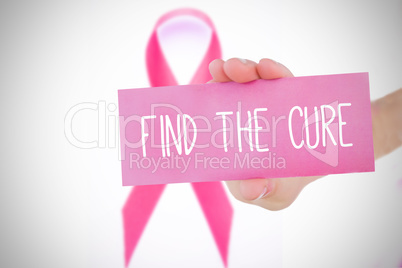 Composite image of young woman holding pink card
