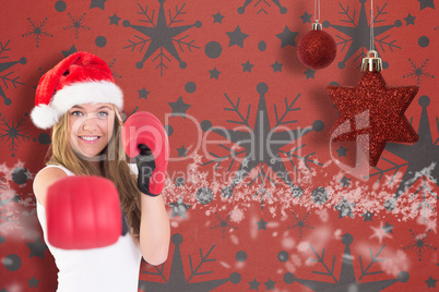 Festive blonde punching with boxing gloves