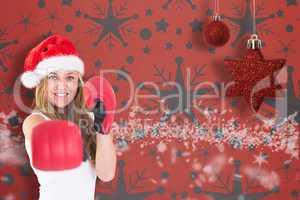 Festive blonde punching with boxing gloves