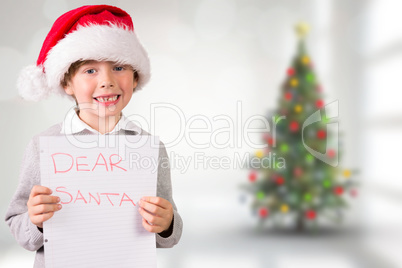 Composite image of festive boy showing letter