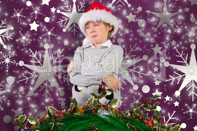 Composite image of festive boy sulking