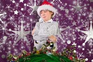 Composite image of festive boy sulking