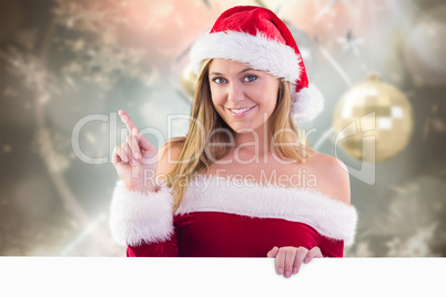 Composite image of festive blonde smiling and pointing