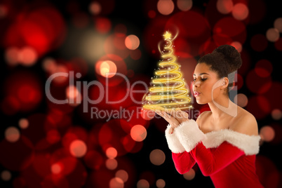 Composite image of pretty santa girl blowing over her hands