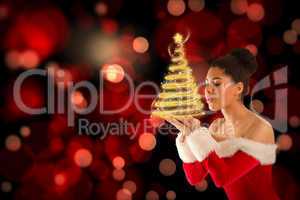 Composite image of pretty santa girl blowing over her hands