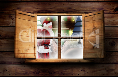 Composite image of santa delivery presents to village