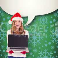 Composite image of festive blonde showing a laptop