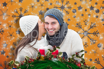 Composite image of winter couple holding gift