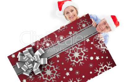 Composite image of festive couple showing poster