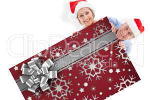 Composite image of festive couple showing poster