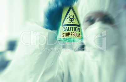 Scientist in protective suit holding beaker