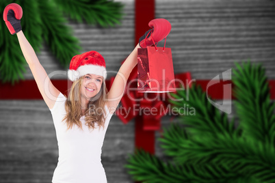 Composite image of festive blonde with boxing gloves and shoppin