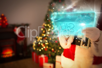 Composite image of santa using futuristic touchscreen