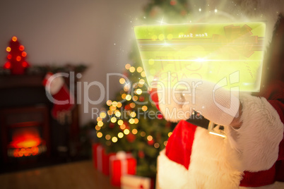 Composite image of santa using futuristic touchscreen