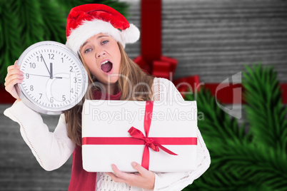 Composite image of festive blonde showing a clock and gift