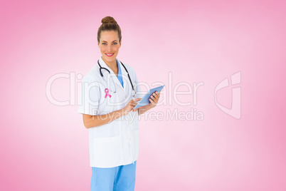 Composite image of pretty nurse using tablet pc