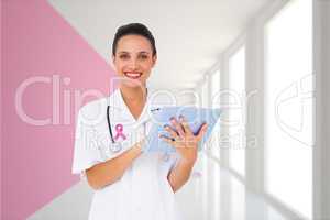 Composite image of pretty nurse using tablet pc