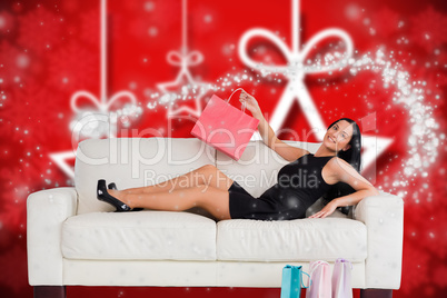 Composite image of woman sitting with shopping bags