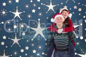 Composite image of man giving woman piggy back