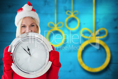 Composite image of happy festive blonde with clock