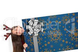 Composite image of festive little girl showing card