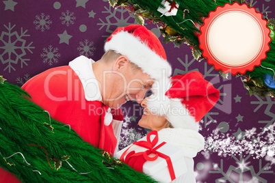 Composite image of festive mature couple holding gift Composite image of festive mature couple holding gift