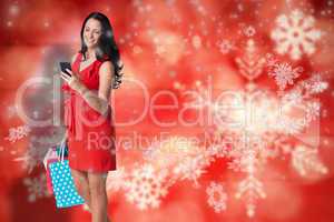 Composite image of woman standing with shopping bags