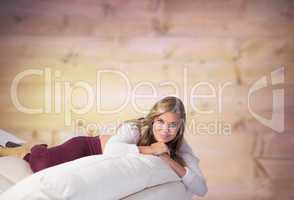 Composite image of pretty blonde relaxing on the couch