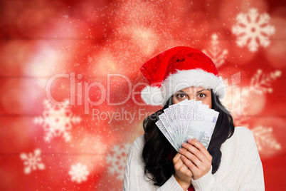 Composite image of woman holding money towards herself