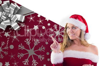Composite image of festive blonde smiling and pointing
