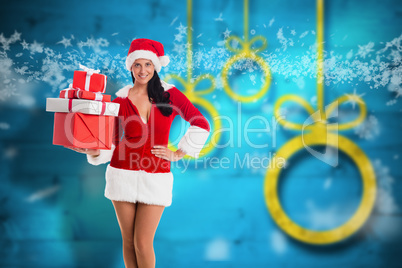 Composite image of woman smiling with christmas presents