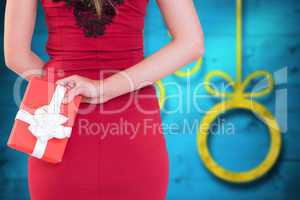 Composite image of classy woman holding a gift