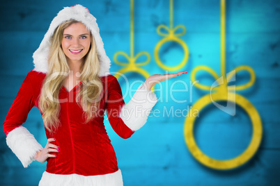 Composite image of pretty girl presenting in santa outfit