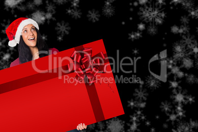 Woman holding a card with red christmas ribbon