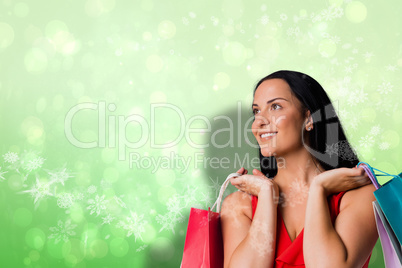 Composite image of woman standing with shopping bags