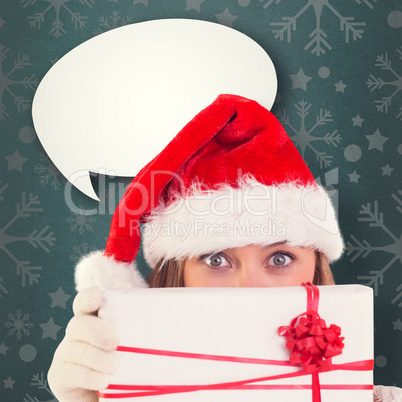 Composite image of festive blonde holding a gift