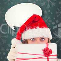 Composite image of festive blonde holding a gift