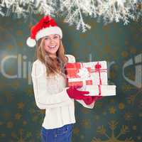 Composite image of festive blonde holding pile of gifts