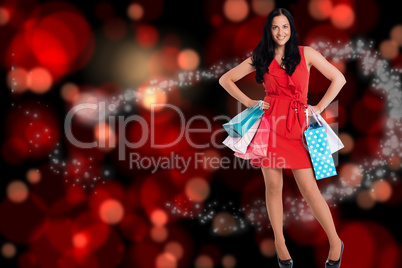 Composite image of woman standing with shopping bags