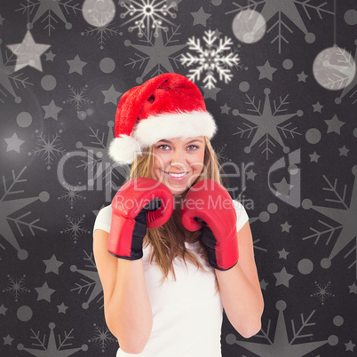 Composite image of festive blonde with boxing gloves