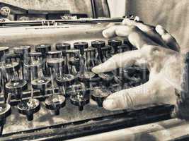 Baby hand typing on a old typewriter