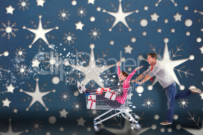 Composite image of man pushing woman in trolley