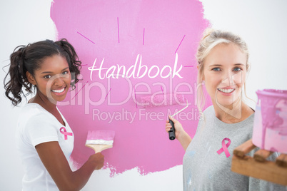 Composite image of smiling housemates painting wall pink