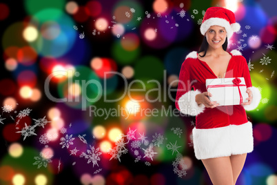 Composite image of woman smiling with christmas present