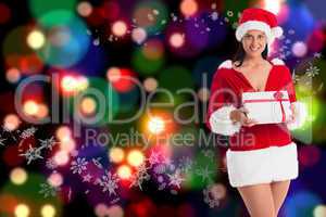 Composite image of woman smiling with christmas present