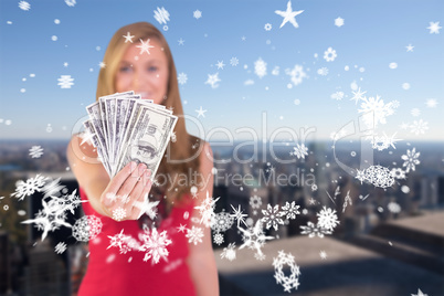 Composite image of pretty blonde showing wad of cash