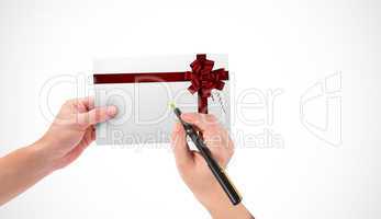 Composite image of hands holding card and pen