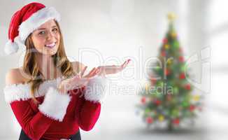 Composite image of sexy santa girl presenting with hands