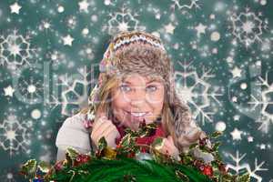 Composite image of happy blonde in winter clothes